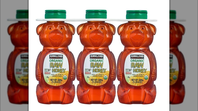 Three bear-shaped bottles full of honey