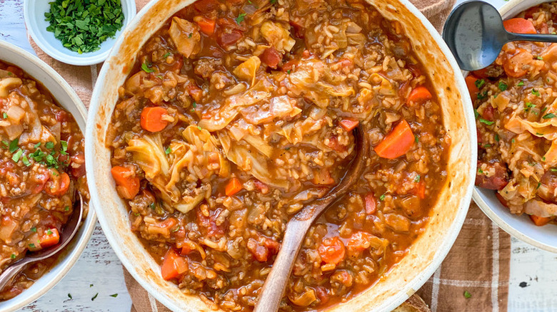 Cabbage roll soup in pot and serving bowls