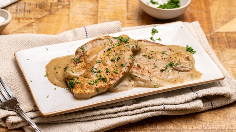 Smothered pork chops on plate