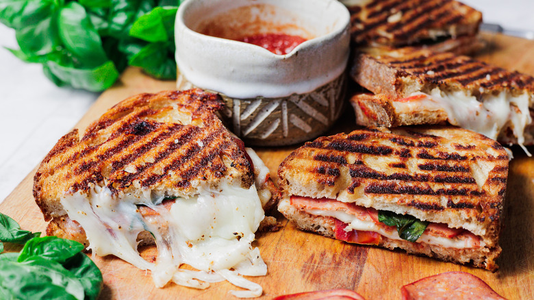 Pizza grilled cheese halves on cutting board