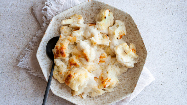Cauliflower au gratin in dish with spoon