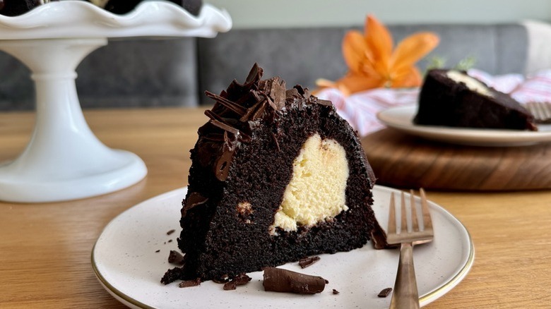 Slice of chocolate cream cheese bundt cake on plate with fork