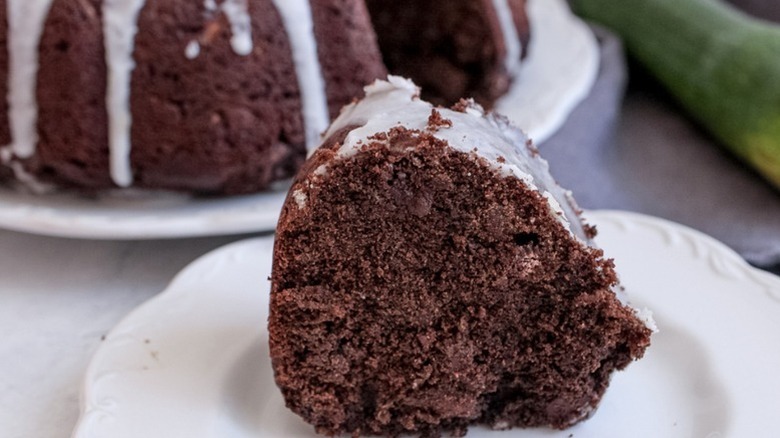 Slice of glazed chocolate bundt cake on plate