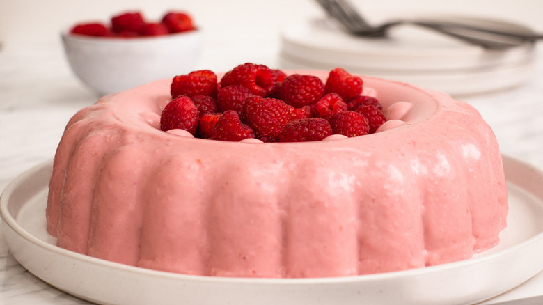 Raspberry blancmange topped with fresh raspberries