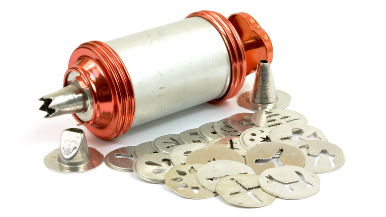 Vintage metal cookie press with various cutters