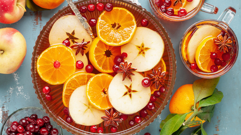 Hot cranberry and apple cider in a punch bowl and glass