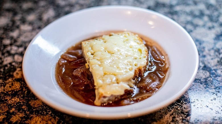Bowl of French onion soup topped with cheesy toast