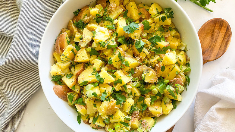 Bowl of herb-topped French potato salad