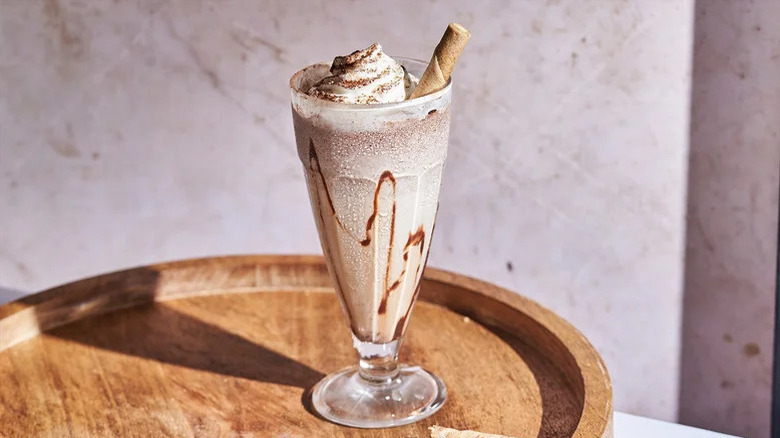 Frozen mudslide cocktail with chocolate swirl, whipped cream, and a wafer