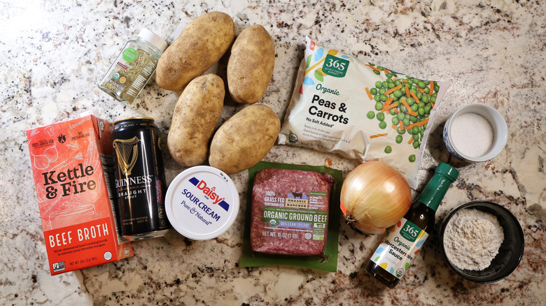 beefy jacket potatoes ingredients laid out on a marble countertop