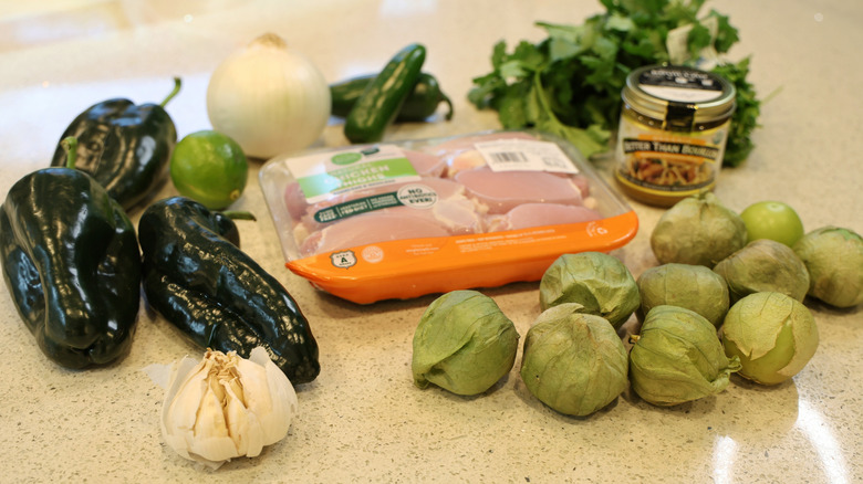verde chicken taco ingredients laid out on a stone countertop