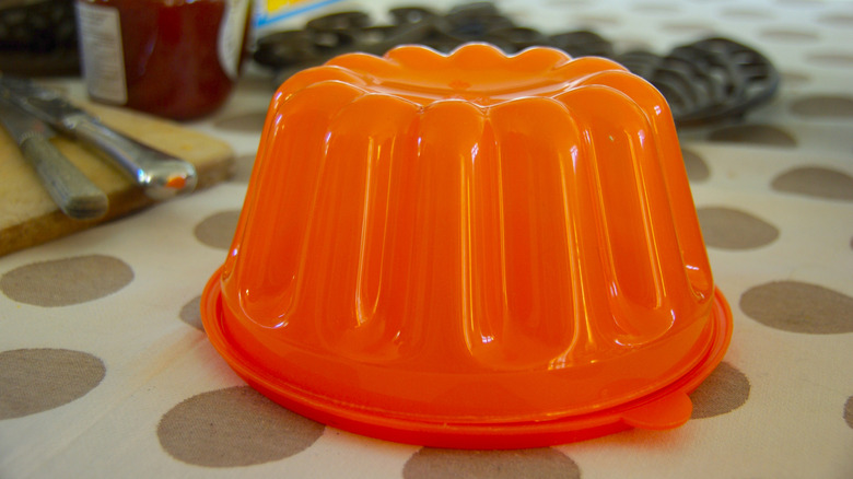 Orange plastic jell-o mold on kitchen countertop