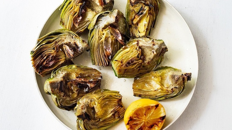 Grilled artichokes on a white plate