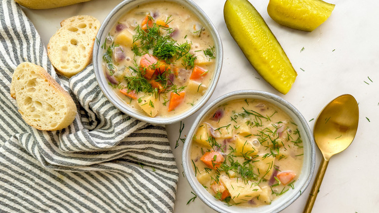 Two bowls of vegetable dill pickle soup