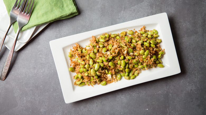 sauteed edamame served on table