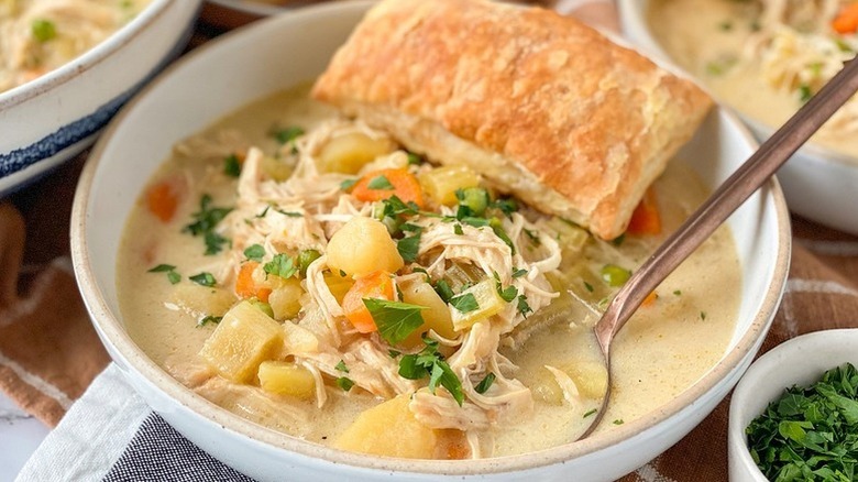 Bowl of Instant Pot chicken pot pie soup with spoon