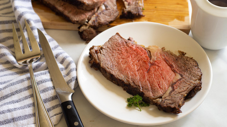 slice of prime rib on a white plate 