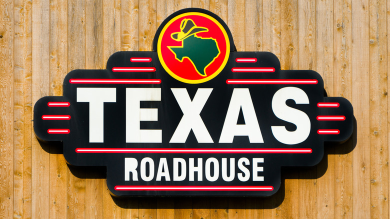 Texas Roadhouse sign on wooden wall
