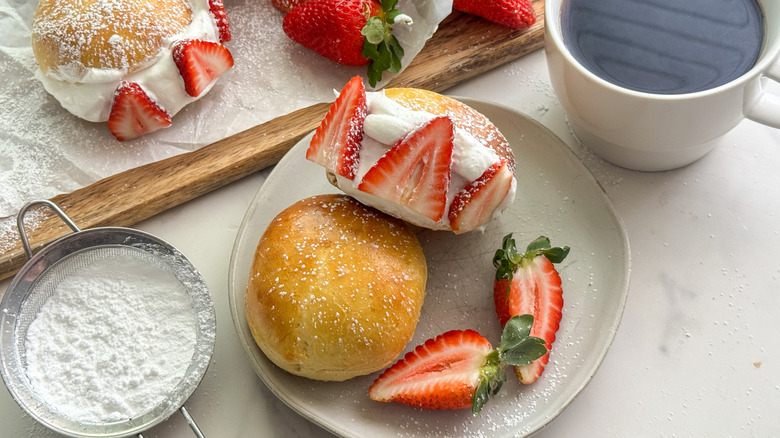 Brioche bun with strawberries and whipped cream