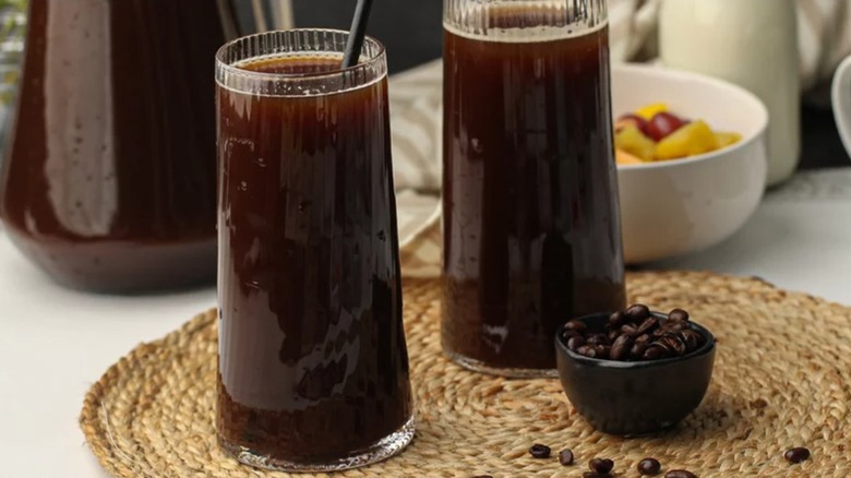 Two glasses of cold brew coffee on table setting