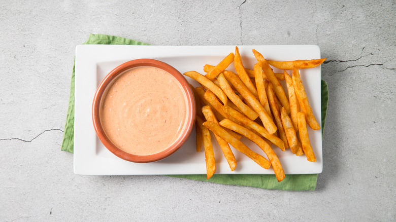 Fries and dip on table