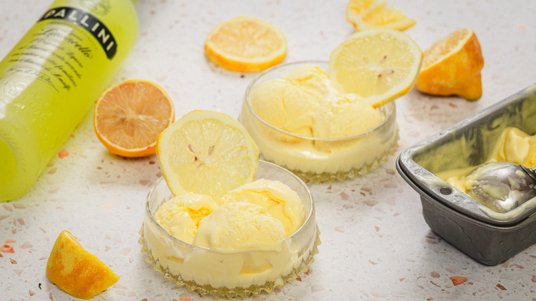 Two servings of lemon gelato, limoncello and lemons