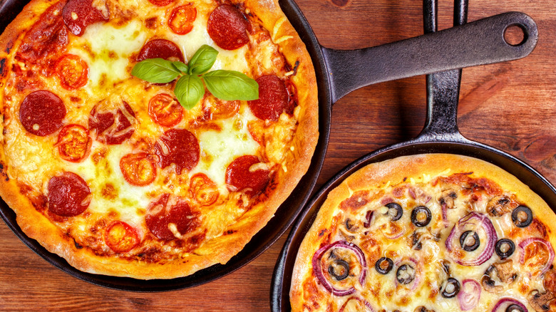 Two large pizzas in skillets