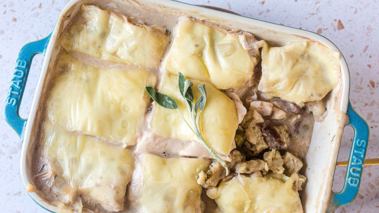 Casserole in baking dish with fresh sage on top