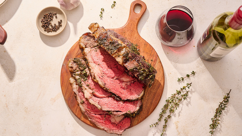 Boneless rib roast sliced on cutting board