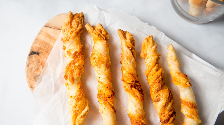 cheese straws on wooden board