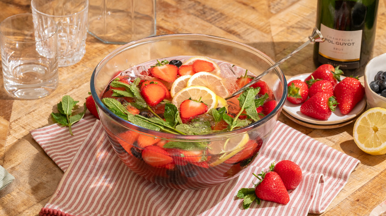 Punch bowl with strawberries, mint, lemon slices