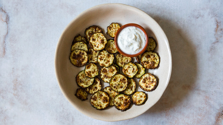 zucchini chips in beige bowl