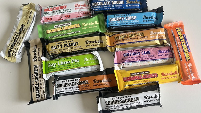 Various Barebells protein bar flavors assembled on a white table