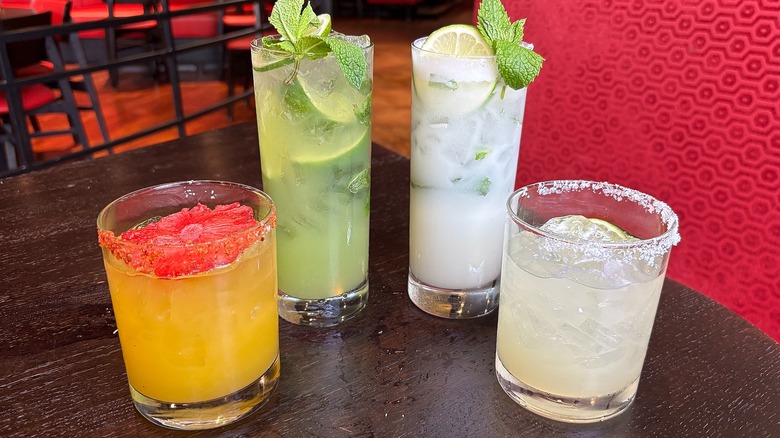 Four P.F. Chang's cocktails on brown table in front of red booth