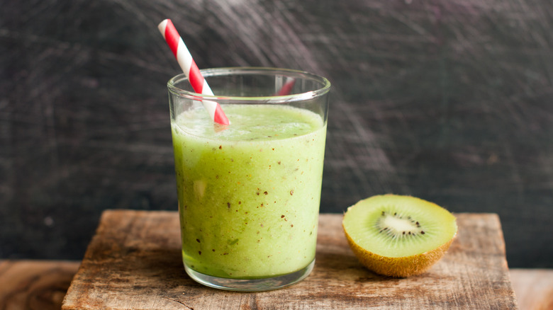 Kiwi juice in glass with straw