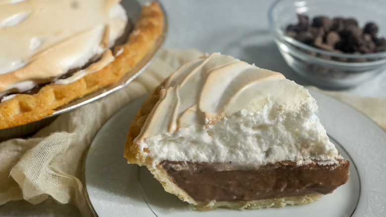 slice of chocolate meringue pie on a white plate