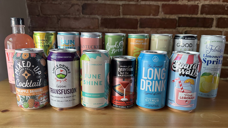 Canned cocktails from Trader Joe's on wooden table with brick background