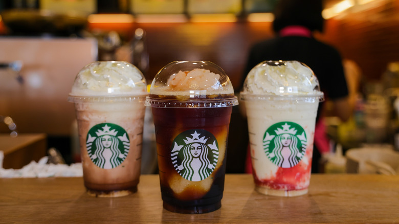 Different Starbucks Frappuccino flavors on a cafe table