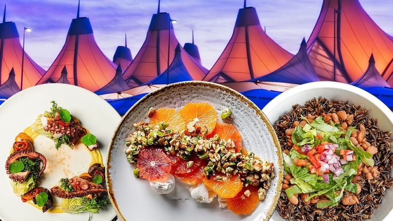 Three plates of brightly colored food against a backdrop of the canopies of the Denver airport