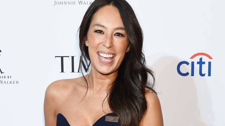 Joanna Gaines smiles with hair down in strapless gown