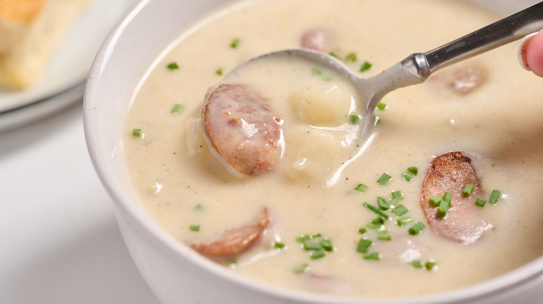 spoonful of sausage and potato soup in bowl