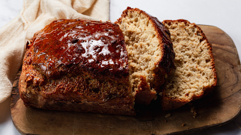 Honey-glazed beer bread on cutting board with napkin