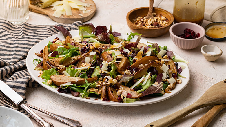 Roasted pear and Manchego salad on white serving platter