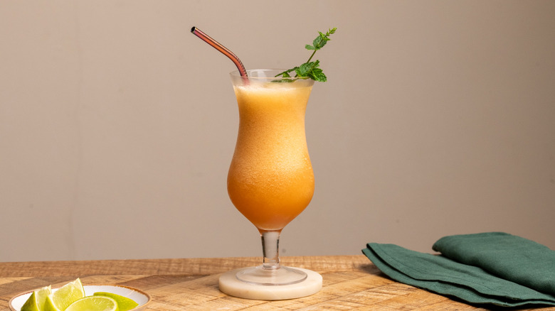 frozen Zombie cocktail with straw and mint sprig