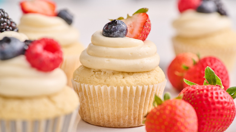 berry chantilly cupcakes on a table