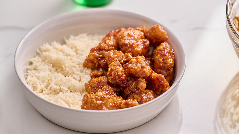 orange chicken in a bowl with rice