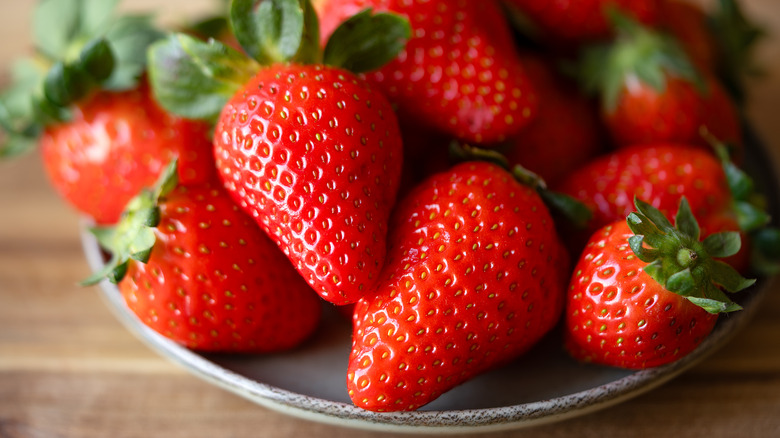 Plate of healthy strawberries on table