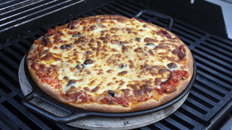 Cheese pizza on grill
