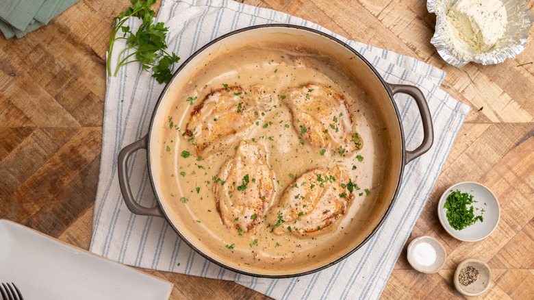 Pork chops in large pot smothered in creamy sauce