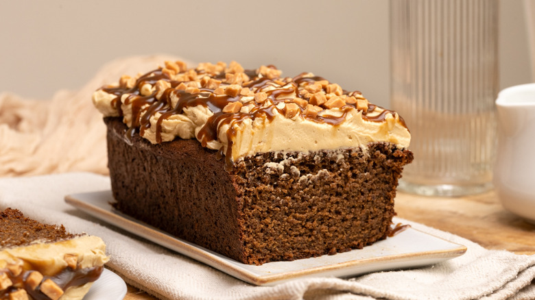 Frosted sticky toffee pudding loaf cake on serving plate